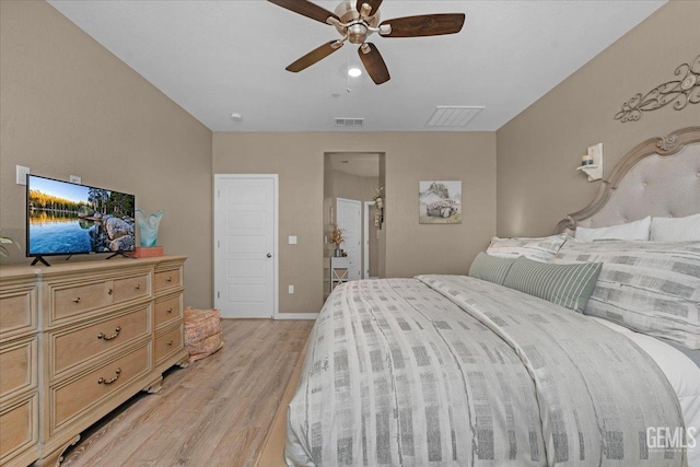 bedroom with baseboards, visible vents, light wood finished floors, and ceiling fan