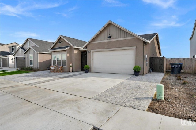 ranch-style house featuring a garage, concrete driveway, stucco siding, and fence