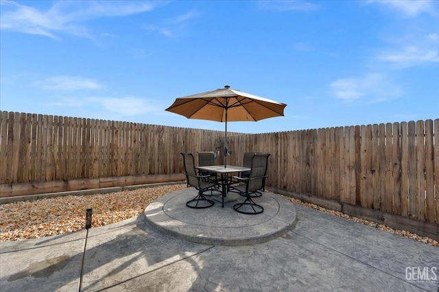 view of patio featuring outdoor dining area and a fenced backyard