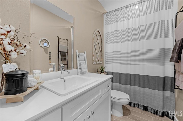 full bath with a shower with shower curtain, toilet, vanity, and wood finish floors