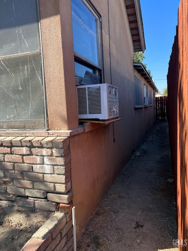 view of home's exterior featuring fence and cooling unit