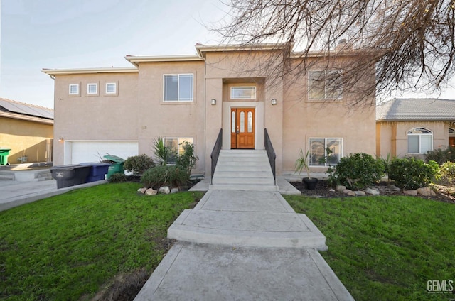 view of front of property featuring a front lawn and a garage