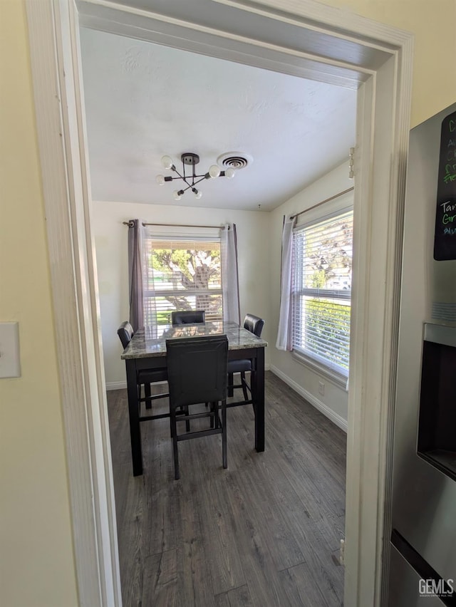 office area with visible vents, plenty of natural light, baseboards, and dark wood-style flooring