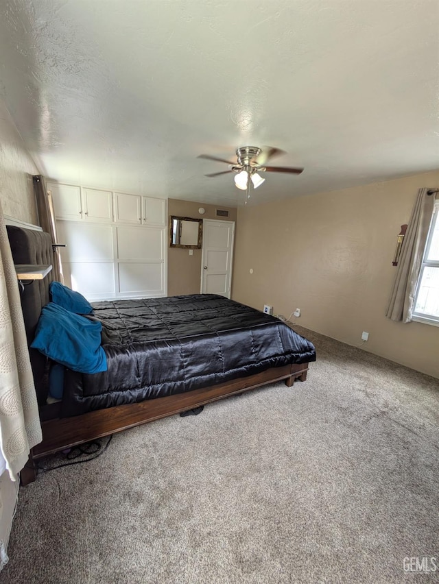 unfurnished bedroom with visible vents, carpet floors, and ceiling fan