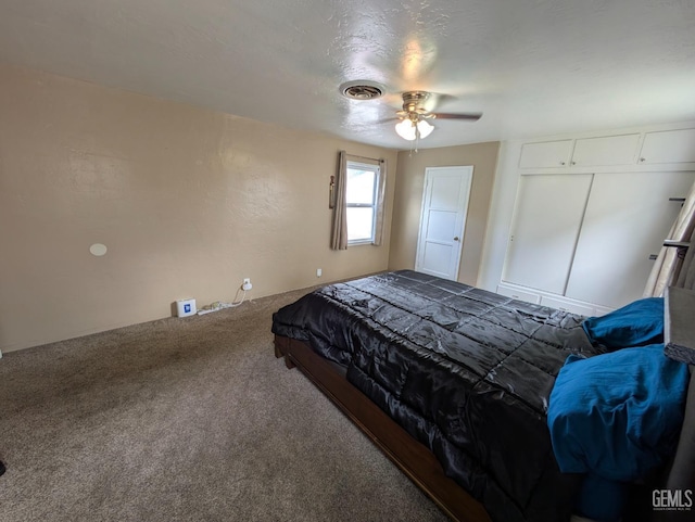 carpeted bedroom with visible vents and a ceiling fan