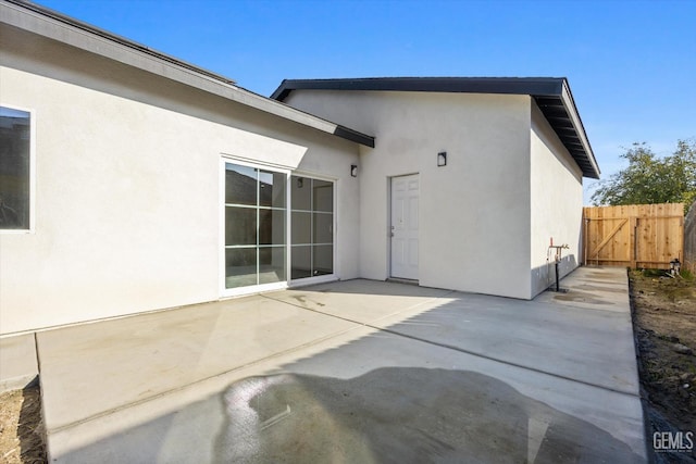 3409 Lotus Ln, Bakersfield, CA 93307 - back of property featuring stucco siding and a patio