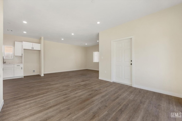 3409 Lotus Ln, Bakersfield, CA 93307 - unfurnished living room with dark wood finished floors and recessed lighting