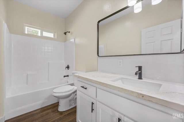 3409 Lotus Ln, Bakersfield, CA 93307 - full bathroom featuring vanity, bathing tub / shower combination, wood finished floors, and tasteful backsplash