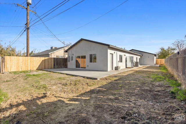 3409 Lotus Ln, Bakersfield, CA 93307 - rear view of property featuring a patio area, stucco siding, and a fenced backyard