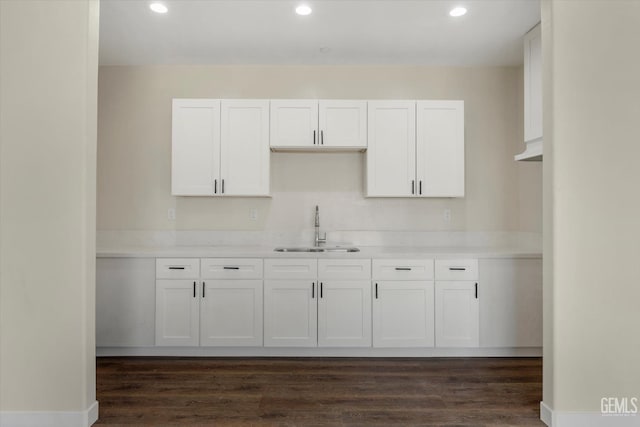3409 Lotus Ln, Bakersfield, CA 93307 - kitchen with white cabinets, recessed lighting, light countertops, and dark wood-style flooring