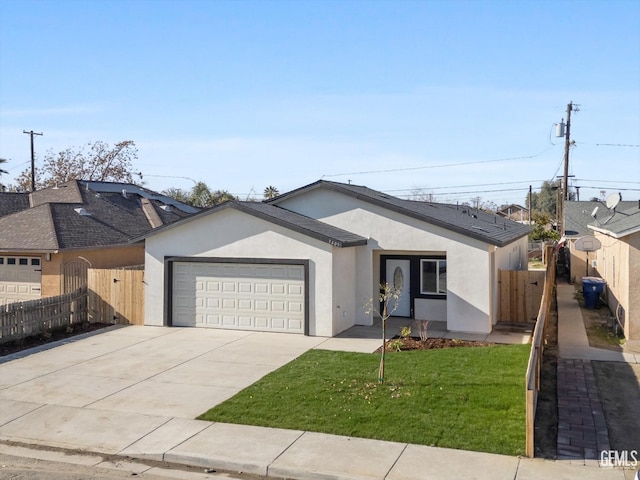 3409 Lotus Ln, Bakersfield, CA 93307 - ranch-style home with stucco siding, a garage, and concrete driveway