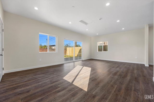 3409 Lotus Ln, Bakersfield, CA 93307 - empty room featuring attic access, dark wood-type flooring, and recessed lighting