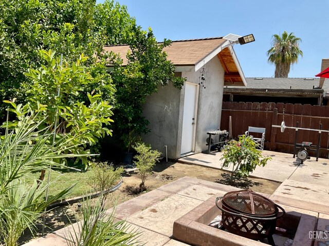 1904 Raymond A Spruance Ct, Bakersfield, CA 93304 - view of patio with an outdoor fire pit and an outbuilding