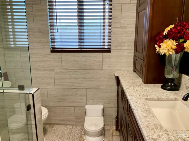 1904 Raymond A Spruance Ct, Bakersfield, CA 93304 - full bathroom with vanity, tile walls, a shower stall, and tile patterned flooring