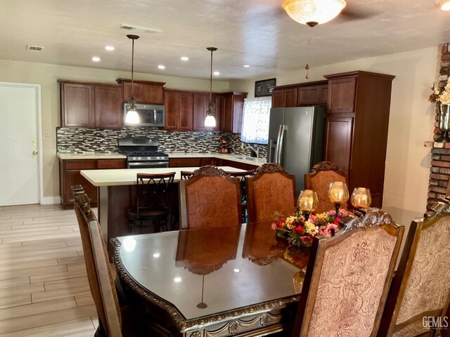 1904 Raymond A Spruance Ct, Bakersfield, CA 93304 - kitchen with stainless steel appliances, backsplash, light countertops, and light wood-type flooring
