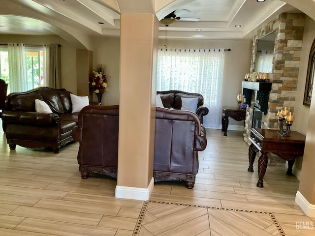1904 Raymond A Spruance Ct, Bakersfield, CA 93304 - living room with arched walkways, wood tiled floors, a ceiling fan, and a tray ceiling