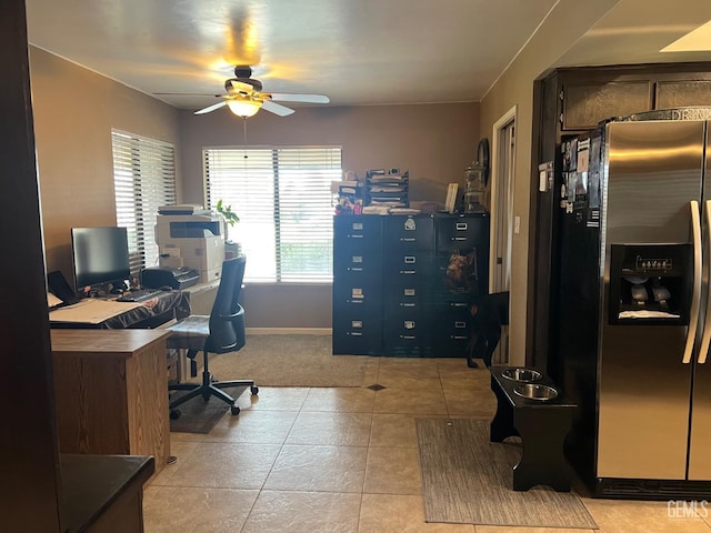 office area with light tile patterned floors and ceiling fan