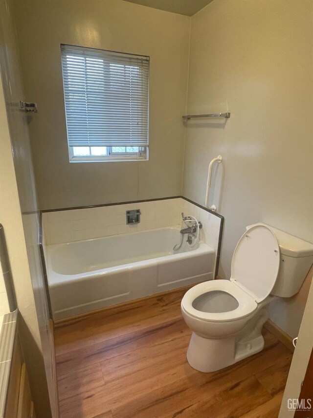 820 Park St, Lodi, CA 95240 - bathroom featuring toilet, wood finished floors, and a bath