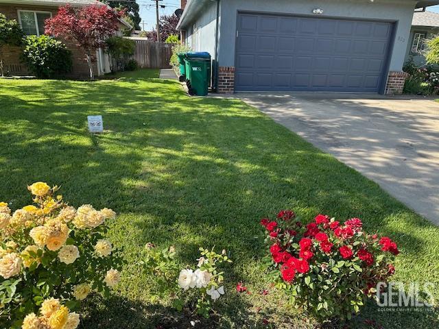 820 Park St, Lodi, CA 95240 - view of yard featuring driveway and an attached garage