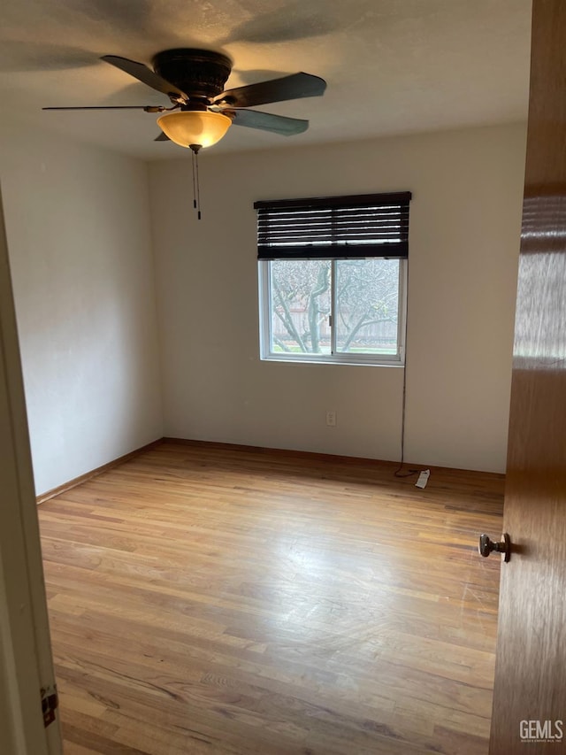 unfurnished room with light wood-type flooring and ceiling fan