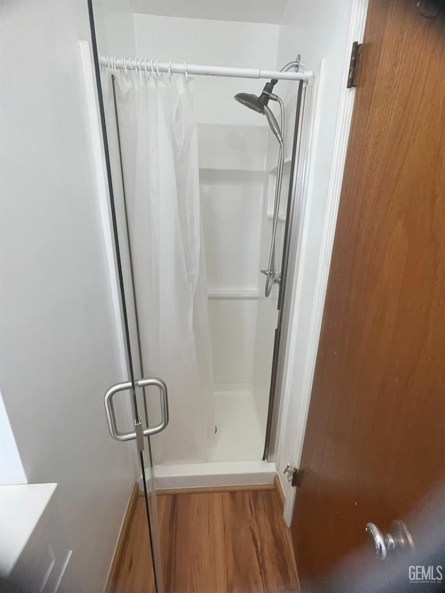 bathroom with wood-type flooring and a shower with curtain