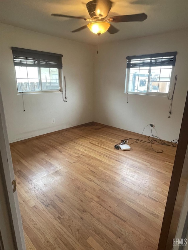 spare room featuring ceiling fan and light hardwood / wood-style floors