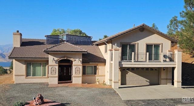 view of front of home with a balcony and a garage