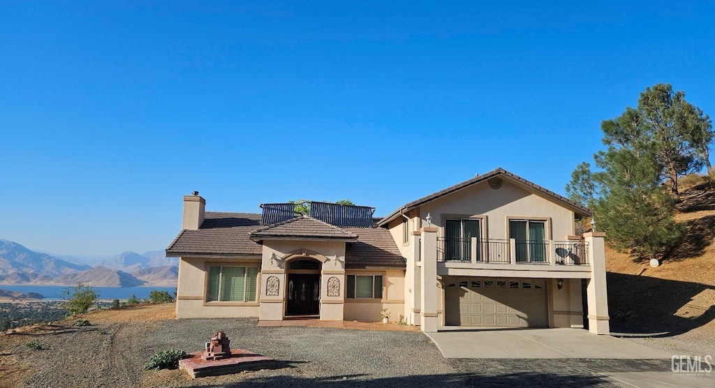 view of front of house with a mountain view, a balcony, and a garage