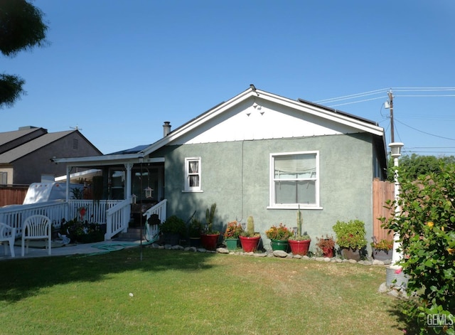 back of property featuring a yard