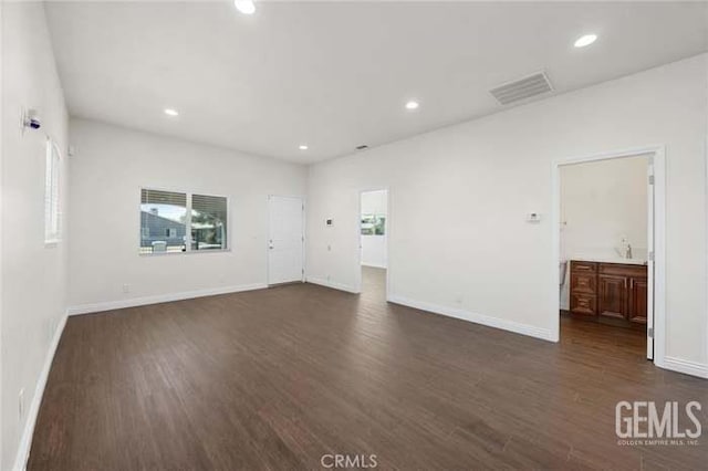 301 Kincaid St, Bakersfield, CA 93307 - spare room with recessed lighting, dark wood-style floors, and baseboards