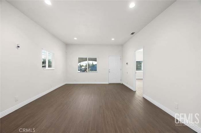 301 Kincaid St, Bakersfield, CA 93307 - unfurnished room with recessed lighting, dark wood-type flooring, and baseboards
