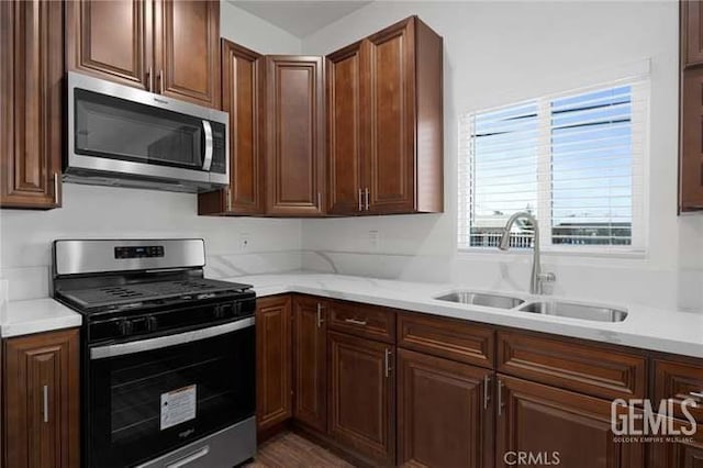 301 Kincaid St, Bakersfield, CA 93307 - kitchen featuring appliances with stainless steel finishes, a sink, and light countertops