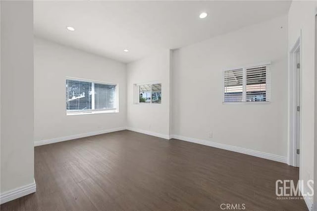 301 Kincaid St, Bakersfield, CA 93307 - empty room with dark wood finished floors, baseboards, and recessed lighting
