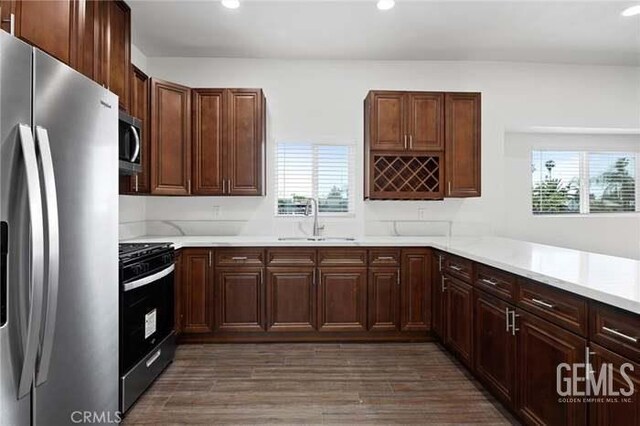 301 Kincaid St, Bakersfield, CA 93307 - kitchen featuring appliances with stainless steel finishes, a sink, healthy amount of natural light, recessed lighting, and light countertops