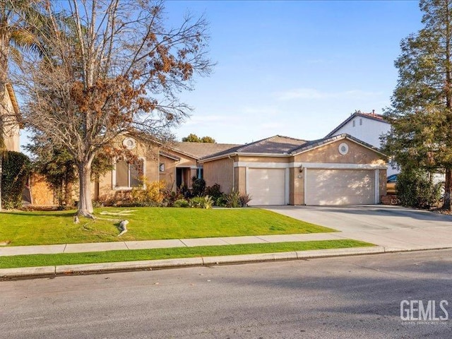 ranch-style house featuring a garage and a front yard