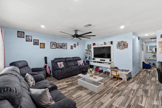 living room featuring ceiling fan and hardwood / wood-style floors