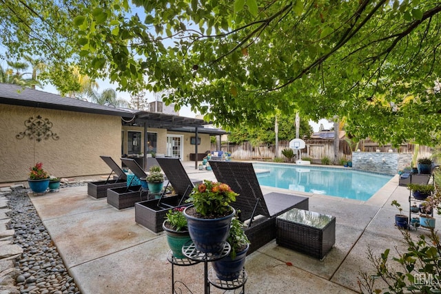 view of swimming pool with a fenced backyard, a fenced in pool, and a patio area