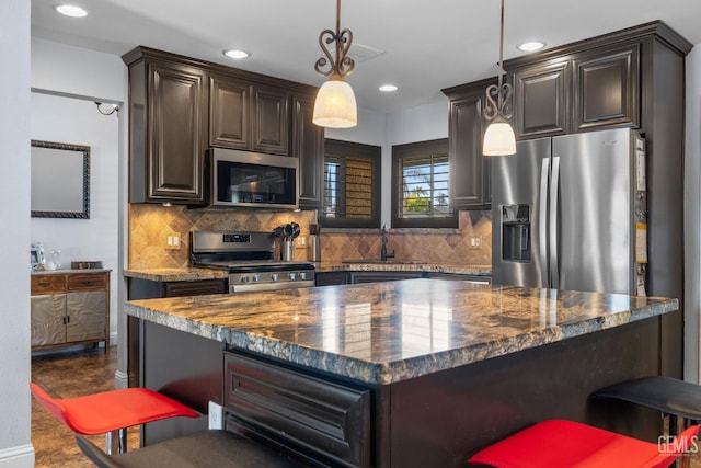 kitchen featuring recessed lighting, appliances with stainless steel finishes, a sink, and tasteful backsplash