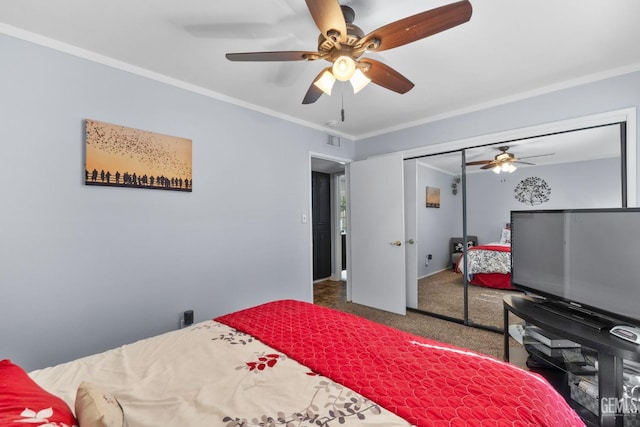 carpeted bedroom featuring visible vents, ornamental molding, and a ceiling fan