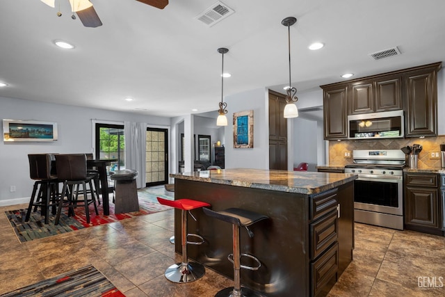 kitchen with visible vents, dark brown cabinetry, tasteful backsplash, and stainless steel appliances