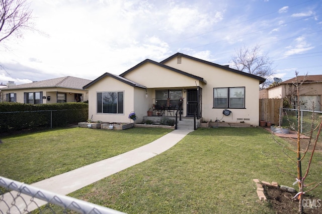 view of front of property featuring fence private yard, a front yard, and stucco siding