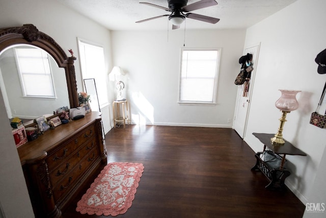 bedroom with a textured ceiling, ceiling fan, wood finished floors, and baseboards