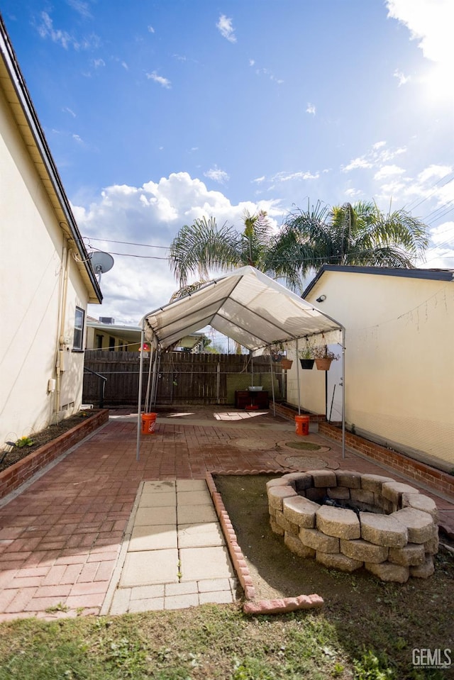 view of patio / terrace featuring an outdoor fire pit and fence