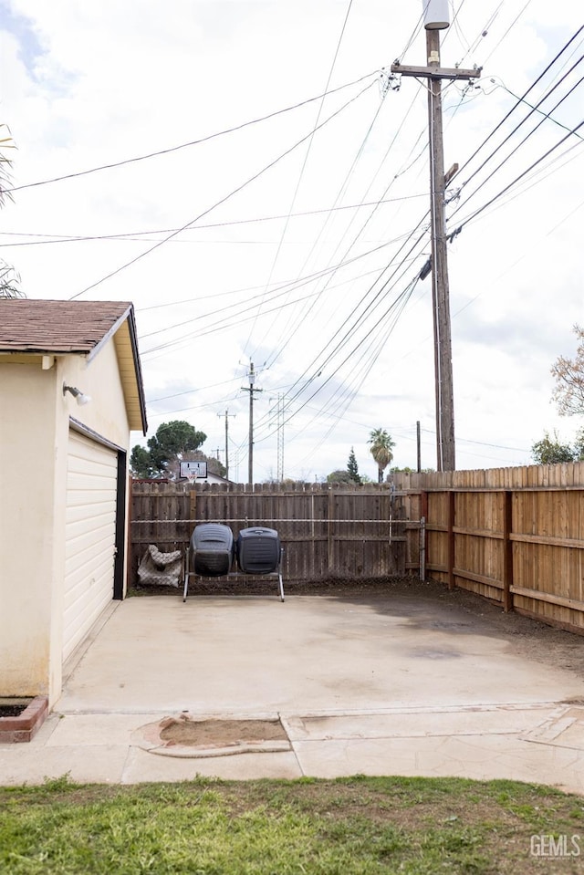 view of patio / terrace featuring an outbuilding and fence