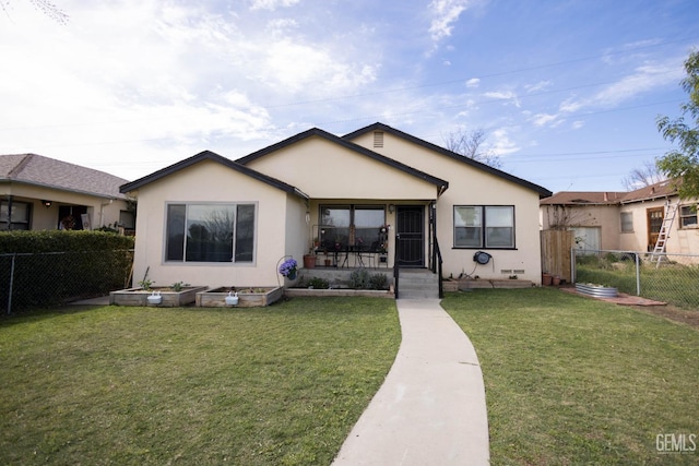 view of front of house with fence private yard, a front yard, and stucco siding