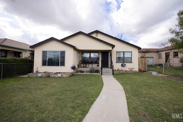 view of front of home featuring a front yard, a fenced backyard, and stucco siding