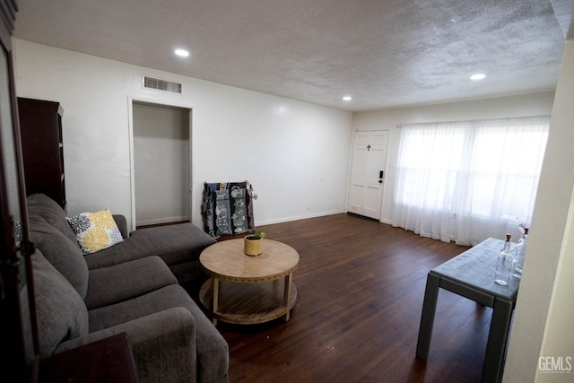 living room with recessed lighting, visible vents, a textured ceiling, wood finished floors, and baseboards