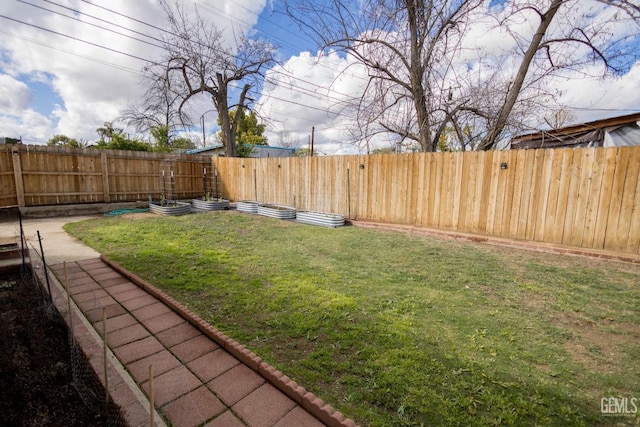 view of yard featuring a garden and a fenced backyard