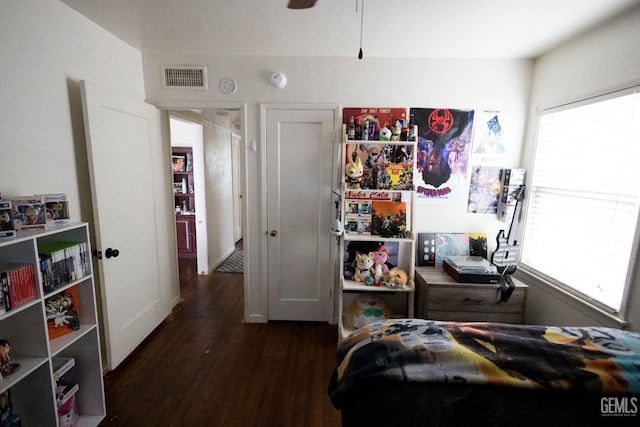 bedroom featuring visible vents and wood finished floors