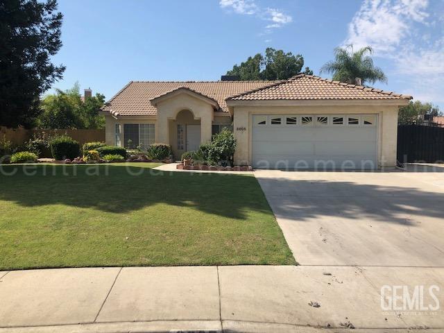 mediterranean / spanish home with a front lawn and a garage